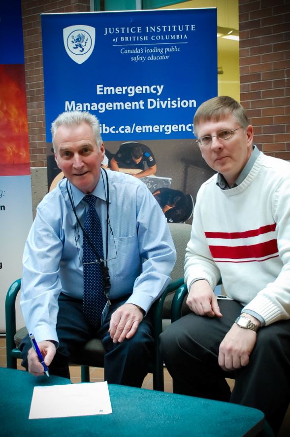 Don Bindon President of BCSARA and Jeff Cornell Program Manager Emergency Management Division signing agreement